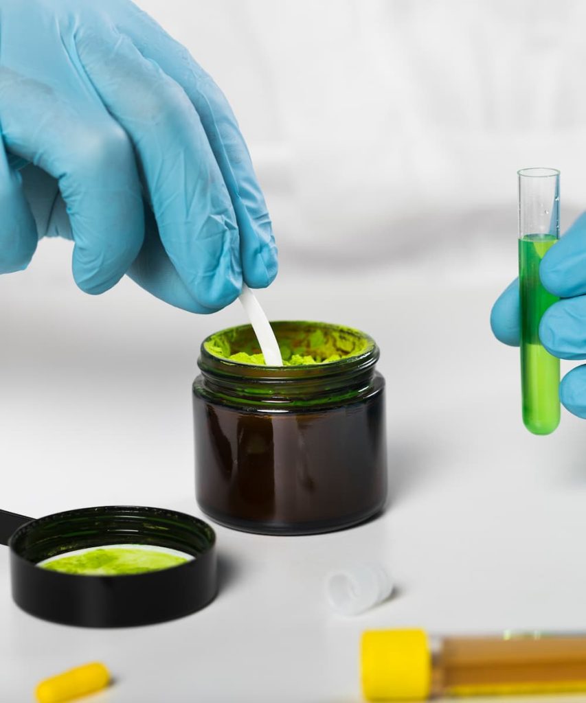 Technician performing detailed product testing in a modern lab environment.